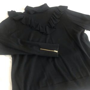 Ruffle turtle neck.